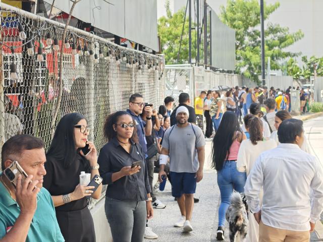 (261009) -- PANAMA CITY, Oct. 9, 2026 (Xinhua) -- People gather outside following an earthquake in Panama City, Panama, Oct. 9, 2026. A major earthquake struck Panama on Friday. (Xinhua/Li Jiaxu)