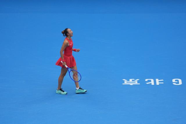 (261010) -- BEIJING, Oct. 10, 2026 (Xinhua) -- Zheng Qinwen of China celebrates scoring during the women's singles quarterfinal match between Zheng Qinwen of China and Elina Svitolina of Ukraine at 2026 China Open tennis tournament in Beijing, China, Oct. 9, 2026. (Xinhua/Xie Han)