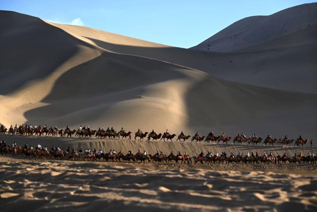 (261010) -- BEIJING, Oct. 10, 2026 (Xinhua) -- Tourists ride camels at the Mingsha Mountain and Crescent Spring scenic area in Dunhuang, northwest China's Gansu Province, Oct. 4, 2026.
  China recorded 826 million domestic tourist trips during the seven-day National Day holiday, with tourism spending totaling 738.38 billion yuan (about 109.67 billion U.S. dollars), the Ministry of Culture and Tourism said Friday.
  On a daily average basis, the number of domestic trips rose 6.3 percent from the eight-day National Day and Mid-Autumn Festival holiday in 2025, while tourism spending increased 4.3 percent, according to the ministry. (Photo by Zhang Xiaoliang/Xinhua)