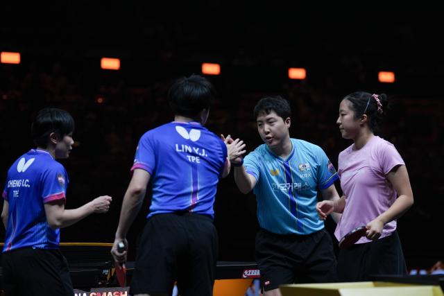 (261010) -- BEIJING, Oct. 10, 2026 (Xinhua) -- Lim Jonghoon (2nd R)/Shin Yubin (1st R) of South Korea and Lin Yun-Ju/Cheng I-Ching (1st L) of Chinese Taipei greet each other after their mixed doubles final match at 2026 World Table Tennis (WTT) China Smash in Beijing, China, Oct. 9, 2026. (Xinhua/Xie Han)