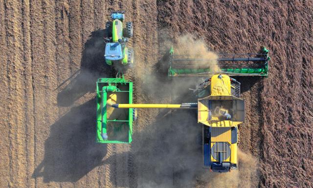 (261010) -- BEIJING, Oct. 10, 2026 (Xinhua) -- An aerial drone photo taken on Oct. 6, 2026 shows harvesters working at a soybean field of a farm under Beidahuang Group in northeast China's Heilongjiang Province. (Photo by Li Xing/Xinhua)