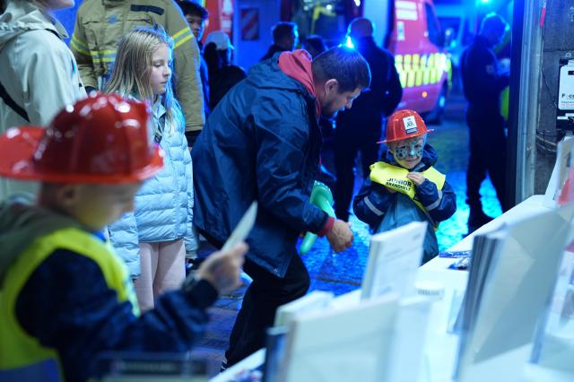 (261010) -- COPENHAGEN, Oct. 10, 2026 (Xinhua) -- Children dress up as firefighters during Culture Night 2026 in Copenhagen, Denmark, Oct. 9, 2026. Copenhagen's annual Culture Night, launched in 1993, took place here on Friday night. Museums, libraries and public institutions opened their doors, offering visitors tours, performances and family activities across Copenhagen. (Photo by Liu Zhichao/Xinhua)