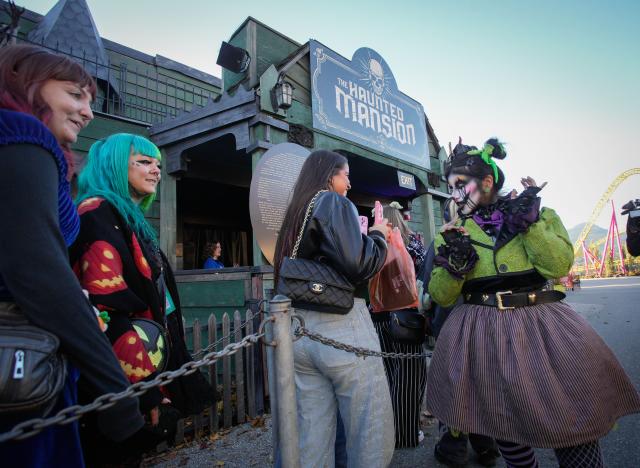 (261010) -- VANCOUVER, Oct. 10, 2026 (Xinhua) -- A costumed actor (R) interacts with visitors outside a haunted house during the Fright Nights 2026 at the Pacific National Exhibition's Playland in Vancouver, British Columbia, Canada, Oct. 9, 2026. The annual Halloween-themed event is held here from Oct. 7 to Oct. 31. (Photo by Liang Sen/Xinhua)