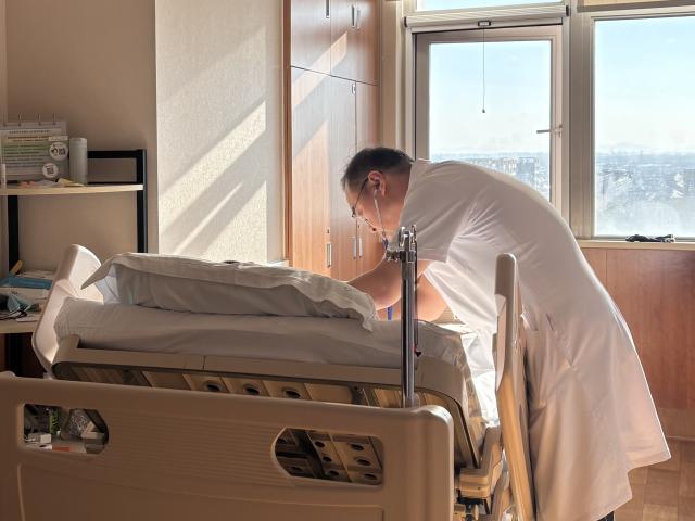 (261010) -- BEIJING, Oct. 10, 2026 (Xinhua) -- Lu Guijun, a doctor at the Department of Pain Medicine, examines a patient at a hospice ward of Beijing Tsinghua Changgung Hospital in Beijing, China, Sept. 28, 2026. TO GO WITH "Feature: The ferryman of life for eternal peace" (Xinhua)