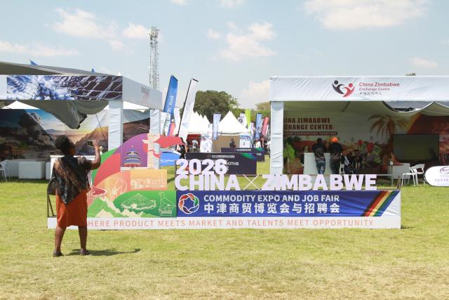 (261010) -- HARARE, Oct. 10, 2026 (Xinhua) -- A woman takes photos at the China-Zimbabwe Commodity Expo and Job Fair in Harare, Zimbabwe, on Oct. 9, 2026. TO GO WITH "Feature: Young Zimbabweans explore employment opportunities with Chinese firms at job fair" (Photo by Tafara Mugwara/Xinhua)