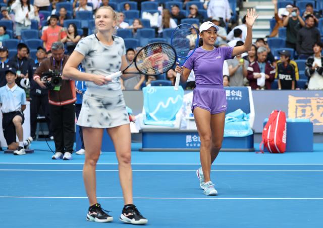 (261010) -- BEIJING, Oct. 10, 2026 (Xinhua) -- Katerina Siniakova/Zhang Shuai (R) greet spectators after winning the women's doubles semifinal match between Katerina Siniakova (the Czech Republic)/Zhang Shuai (China) and Erin Routliffe (New Zealand)/Aldila Sutjiadi (Indonesia) at 2026 China Open tennis tournament in Beijing, China, Oct. 10, 2026. (Xinhua/Zhang Chenlin)