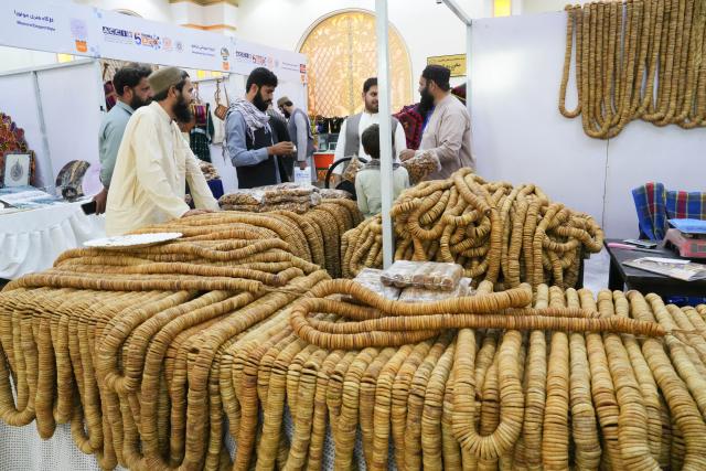(261010) -- KABUL, Oct. 10, 2026 (Xinhua) -- People visit a booth for Afghan agricultural goods at a trade exhibition in Kabul, Afghanistan, Oct. 7, 2026. A major trade exhibition opened in Kabul, attracting hundreds of domestic and foreign investors to boost Afghanistan's trade ties with neighboring countries and unlock fresh opportunities for trade and investment. 
  TO GO WITH "Feature: Local trade exhibition bridges Afghan, int'l markets" (Photo by Saifurahman Safi/Xinhua)