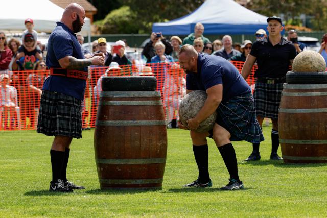 (261010) -- CANBERRA, Oct. 10, 2026 (Xinhua) -- A competitor takes part in the stone-lifting competition during the Canberra Highland Gathering in Canberra, Australia, on Oct. 10, 2026. The Scottish cultural event featuring traditional sports, bagpipe and drum performances, dance and traditional food was held in Canberra on Saturday. (Photo by Chu Chen/Xinhua)