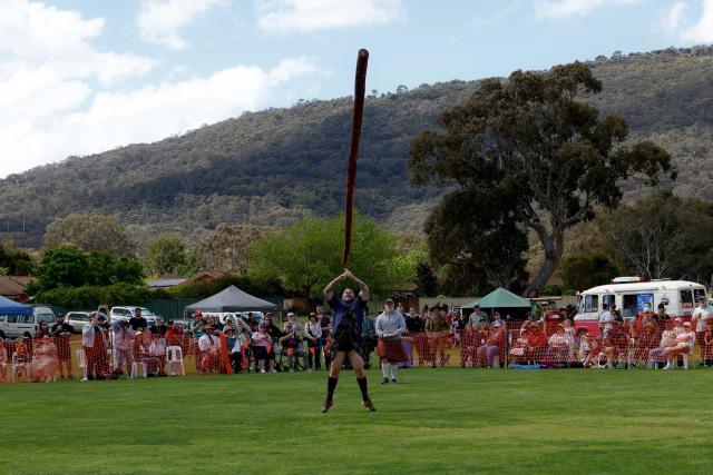 (261010) -- CANBERRA, Oct. 10, 2026 (Xinhua) -- A competitor takes part in the caber toss competition during the Canberra Highland Gathering in Canberra, Australia, on Oct. 10, 2026. The Scottish cultural event featuring traditional sports, bagpipe and drum performances, dance and traditional food was held in Canberra on Saturday. (Photo by Chu Chen/Xinhua)