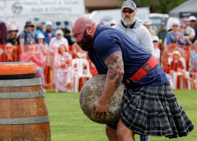 (261010) -- CANBERRA, Oct. 10, 2026 (Xinhua) -- A competitor takes part in the stone-lifting competition during the Canberra Highland Gathering in Canberra, Australia, on Oct. 10, 2026. The Scottish cultural event featuring traditional sports, bagpipe and drum performances, dance and traditional food was held in Canberra on Saturday. (Photo by Chu Chen/Xinhua)