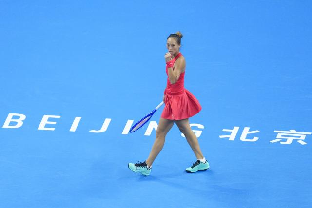 (261010) -- BEIJING, Oct. 10, 2026 (Xinhua) -- Zheng Qinwen celebrates scoring during the women's singles semifinal between Zheng Qinwen of China and Elise Mertens of Belgium at 2026 China Open tennis tournament in Beijing, China, Oct. 10, 2026. (Xinhua/Ju Huanzong)