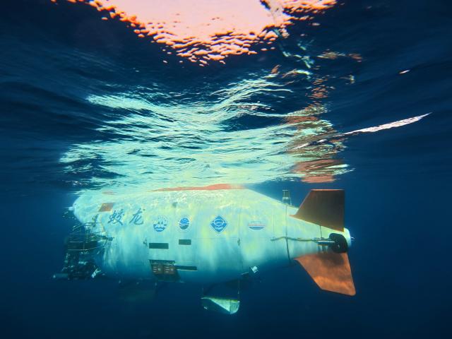 (261010) -- ABOARD RESEARCH VESSEL DEEP SEA NO. 1, Oct. 10, 2026 (Xinhua) -- China's manned deep-sea submersible Jiaolong prepares to dive after safety inspection in the western Pacific Ocean, Oct. 10, 2026. China's research vessel Deep Sea No. 1, carrying manned deep-sea submersible Jiaolong, arrived at East Caroline Basin in the western Pacific Ocean on Saturday for deep-sea scientific research.
   This marks the 466th dive of Jiaolong, with a planned diving depth of about 4,500 meters. (Xinhua/Li Xin)