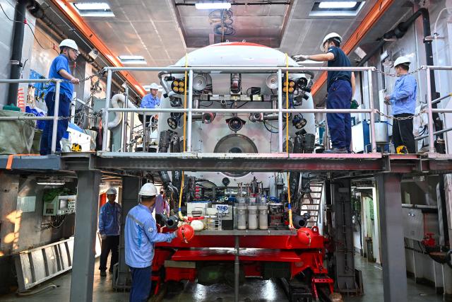 (261010) -- ABOARD RESEARCH VESSEL DEEP SEA NO. 1, Oct. 10, 2026 (Xinhua) -- Staff members conduct pre-dive safety checks on the manned deep-sea submersible Jiaolong aboard the research vessel Deep Sea No. 1 in the western Pacific Ocean, on Oct. 10, 2026. China's research vessel Deep Sea No. 1, carrying manned deep-sea submersible Jiaolong, arrived at East Caroline Basin in the western Pacific Ocean on Saturday for deep-sea scientific research.
   This marks the 466th dive of Jiaolong, with a planned diving depth of about 4,500 meters. (Xinhua/Li Xin)