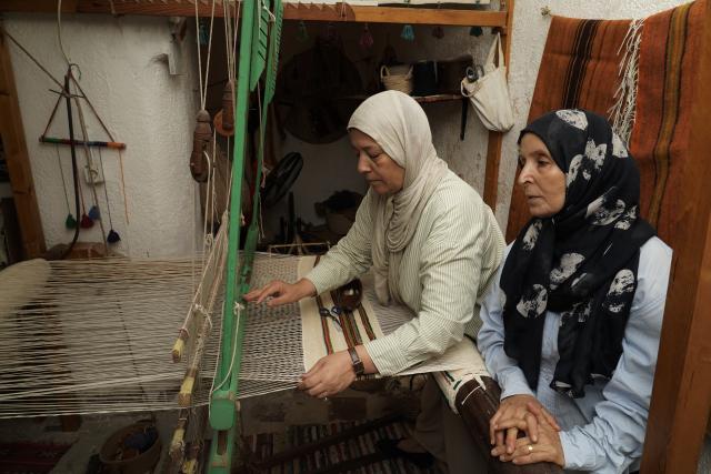 (261010) -- TRIPOLI, Oct. 10, 2026 (Xinhua) -- Aisha Madi (R) and Zeinab Madi work in a workshop in Tripoli, Libya, Sept. 29, 2026. TO GO WITH "Feature: Thread by thread, Libyan women keep an age-old craft alive" (Photo by Hazem Turkia/Xinhua)