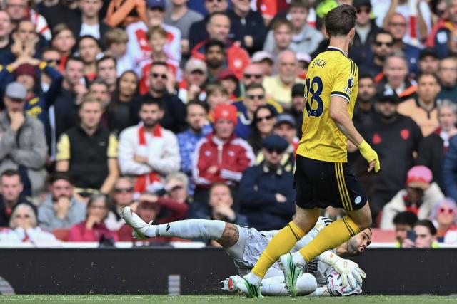 (261011) -- LONDON, Oct. 11, 2026 (Xinhua) -- David Raya (bottom), goalkeeper of Arsenal makes a save ahead of Anton Stach of Leeds United during the English Premier League match between Arsenal and Leeds United in London, Britain, on Oct. 10, 2026. (Xinhua)