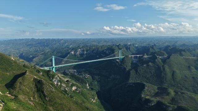 (261011) -- ZUNYI, Oct. 11, 2026 (Xinhua) -- An aerial drone photo taken on July 31, 2026 shows the Huajiang Grand Canyon Bridge in southwest China's Guizhou Province. (Xinhua)