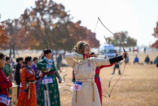 (261011) -- HINGGAN LEAGUE, Oct. 11, 2026 (Xinhua) -- An archery contestant competes during a maple-themed cultural tourism season in Horqin Right Wing Middle Banner of Hinggan League, north China's Inner Mongolia Autonomous Region, Oct. 11, 2026. A maple-themed cultural tourism season kicked off here on Sunday, featuring autumn maple viewing, cultural experiences and leisure activities. (Xinhua/Bei He)