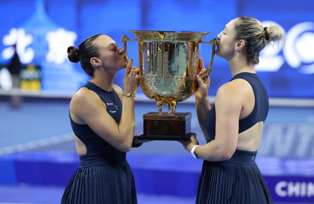 (261011) -- BEIJING, Oct. 11, 2026 (Xinhua) -- Winner Gabriela Dabrowski (R) of Canada/Luisa Stefani of Brazil kiss the trophy during the awarding ceremony for the women's doubles at 2026 China Open tennis tournament in Beijing, China, Oct. 11, 2026. (Xinhua/Zhang Chenlin)