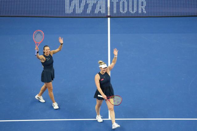 (261011) -- BEIJING, Oct. 11, 2026 (Xinhua) -- Gabriela Dabrowski (R) of Canada/Luisa Stefani of Brazil greet the spectators after the women's doubles final against Katerina Siniakova of the Czech Republic/Zhang Shuai of China at 2026 China Open tennis tournament in Beijing, China, Oct. 11, 2026. (Xinhua/Ju Huanzong)