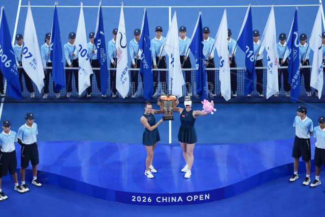 (261011) -- BEIJING, Oct. 11, 2026 (Xinhua) -- Winner Gabriela Dabrowski (3rd R, front) of Canada/Luisa Stefani (3rd L, front) of Brazil pose during the awarding ceremony for the women's doubles at 2026 China Open tennis tournament in Beijing, China, Oct. 11, 2026. (Xinhua/Ju Huanzong)