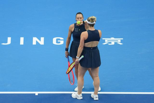 (261011) -- BEIJING, Oct. 11, 2026 (Xinhua) -- Gabriela Dabrowski (R) of Canada/Luisa Stefani of Brazil communicate during the women's doubles final against Katerina Siniakova of the Czech Republic/Zhang Shuai of China at 2026 China Open tennis tournament in Beijing, China, Oct. 11, 2026. (Xinhua/Ju Huanzong)