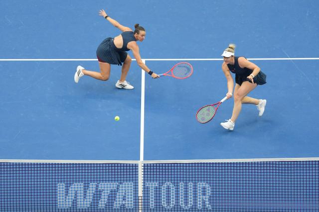 (261011) -- BEIJING, Oct. 11, 2026 (Xinhua) -- Gabriela Dabrowski (R) of Canada/Luisa Stefani of Brazil compete during the women's doubles final against Katerina Siniakova of the Czech Republic/Zhang Shuai of China at 2026 China Open tennis tournament in Beijing, China, Oct. 11, 2026. (Xinhua/Ju Huanzong)