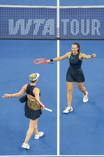 (261011) -- BEIJING, Oct. 11, 2026 (Xinhua) -- Gabriela Dabrowski (L) of Canada/Luisa Stefani of Brazil celebrate after the women's doubles final against Katerina Siniakova of the Czech Republic/Zhang Shuai of China at 2026 China Open tennis tournament in Beijing, China, Oct. 11, 2026. (Xinhua/Ju Huanzong)