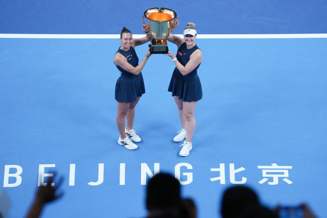 (261011) -- BEIJING, Oct. 11, 2026 (Xinhua) -- Winner Gabriela Dabrowski (R) of Canada/Luisa Stefani of Brazil pose during the awarding ceremony for the women's doubles at 2026 China Open tennis tournament in Beijing, China, Oct. 11, 2026. (Xinhua/Ju Huanzong)