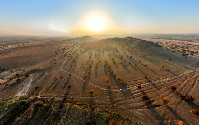 (261011) -- HINGGAN LEAGUE, Oct. 11, 2026 (Xinhua) -- An aerial drone photo taken on Oct. 11, 2026 shows the sunrise on Daiqin Tal grassland in Horqin Right Wing Middle Banner of Hinggan League, north China's Inner Mongolia Autonomous Region. (Xinhua/Bei He)
