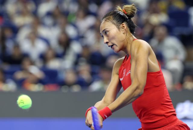 (261011) -- BEIJING, Oct. 11, 2026 (Xinhua) -- Zheng Qinwen hits a return during the women's singles final between Zheng Qinwen of China and Mirra Andreeva of Russia at 2026 China Open tennis tournament in Beijing, China, Oct. 11, 2026. (Xinhua/Zhang Chenlin)
