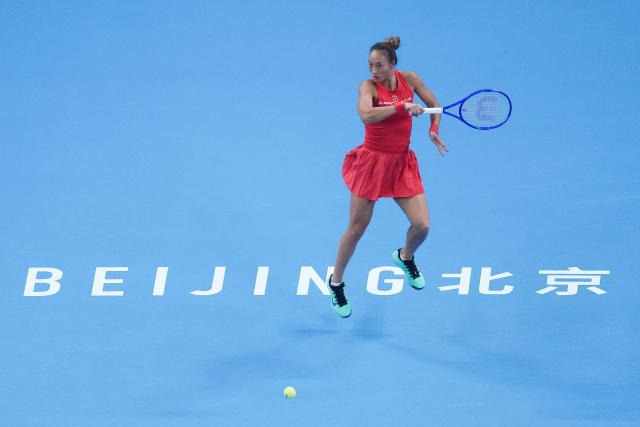 (261011) -- BEIJING, Oct. 11, 2026 (Xinhua) -- Zheng Qinwen hits a return during the women's singles final between Zheng Qinwen of China and Mirra Andreeva of Russia at 2026 China Open tennis tournament in Beijing, China, Oct. 11, 2026. (Xinhua/Ju Huanzong)