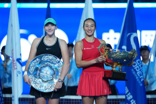 (261011) -- BEIJING, Oct. 11, 2026 (Xinhua) -- Zheng Qinwen (R) and Mirra Andreeva pose with their trophies during the awarding ceremony after the women's singles final between Zheng Qinwen of China and Mirra Andreeva of Russia at 2026 China Open tennis tournament in Beijing, China, Oct. 11, 2026. (Xinhua/Sun Fei)