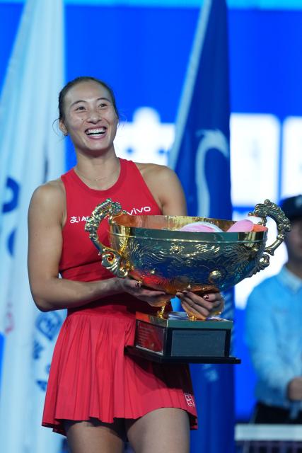 (261011) -- BEIJING, Oct. 11, 2026 (Xinhua) -- Zheng Qinwen poses with the trophy during the awarding ceremony after the women's singles final between Zheng Qinwen of China and Mirra Andreeva of Russia at 2026 China Open tennis tournament in Beijing, China, Oct. 11, 2026. (Xinhua/Sun Fei)