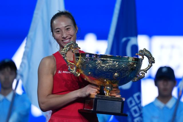 (261011) -- BEIJING, Oct. 11, 2026 (Xinhua) -- Zheng Qinwen poses with the trophy during the awarding ceremony after the women's singles final between Zheng Qinwen of China and Mirra Andreeva of Russia at 2026 China Open tennis tournament in Beijing, China, Oct. 11, 2026. (Xinhua/Sun Fei)