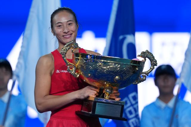 (261011) -- BEIJING, Oct. 11, 2026 (Xinhua) -- Zheng Qinwen poses with the trophy during the awarding ceremony after the women's singles final between Zheng Qinwen of China and Mirra Andreeva of Russia at 2026 China Open tennis tournament in Beijing, China, Oct. 11, 2026. (Xinhua/Sun Fei)