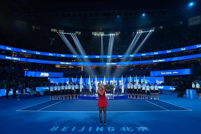 (261011) -- BEIJING, Oct. 11, 2026 (Xinhua) -- Zheng Qinwen kisses the trophy during the awarding ceremony after the women's singles final between Zheng Qinwen of China and Mirra Andreeva of Russia at 2026 China Open tennis tournament in Beijing, China, Oct. 11, 2026. (Xinhua/Sun Fei)
