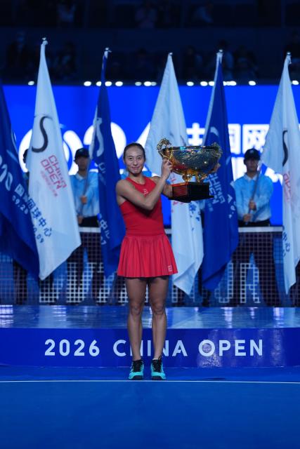 (261011) -- BEIJING, Oct. 11, 2026 (Xinhua) -- Zheng Qinwen poses with the trophy during the awarding ceremony after the women's singles final between Zheng Qinwen of China and Mirra Andreeva of Russia at 2026 China Open tennis tournament in Beijing, China, Oct. 11, 2026. (Xinhua/Sun Fei)