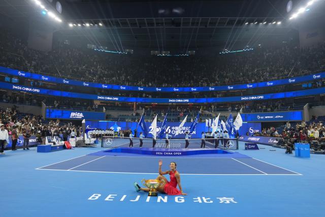 (261011) -- BEIJING, Oct. 11, 2026 (Xinhua) -- Zheng Qinwen poses with the trophy during the awarding ceremony after the women's singles final between Zheng Qinwen of China and Mirra Andreeva of Russia at 2026 China Open tennis tournament in Beijing, China, Oct. 11, 2026. (Xinhua/Sun Fei)