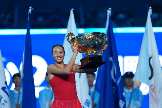 (261011) -- BEIJING, Oct. 11, 2026 (Xinhua) -- Zheng Qinwen poses with the trophy during the awarding ceremony after the women's singles final between Zheng Qinwen of China and Mirra Andreeva of Russia at 2026 China Open tennis tournament in Beijing, China, Oct. 11, 2026. (Xinhua/Sun Fei)