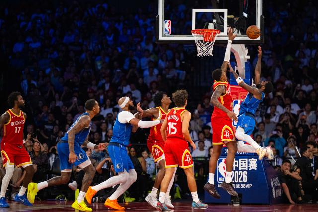 (261011) -- MACAO, Oct. 11, 2026 (Xinhua) -- Kyrie Irving (1st R) of Dallas Mavericks shoots during the 2026-2027 NBA preseason game between Dallas Mavericks and Houston Rockets in Macao, south China, on Oct. 11, 2026. (Xinhua/Cheong Kam Ka)