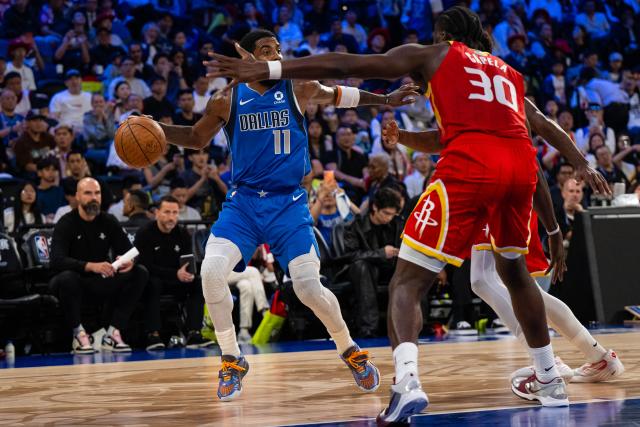 (261011) -- MACAO, Oct. 11, 2026 (Xinhua) -- Kyrie Irving (L) of Dallas Mavericks dribbles during the 2026-2027 NBA preseason game between Dallas Mavericks and Houston Rockets in Macao, south China, on Oct. 11, 2026. (Xinhua/Cheong Kam Ka)