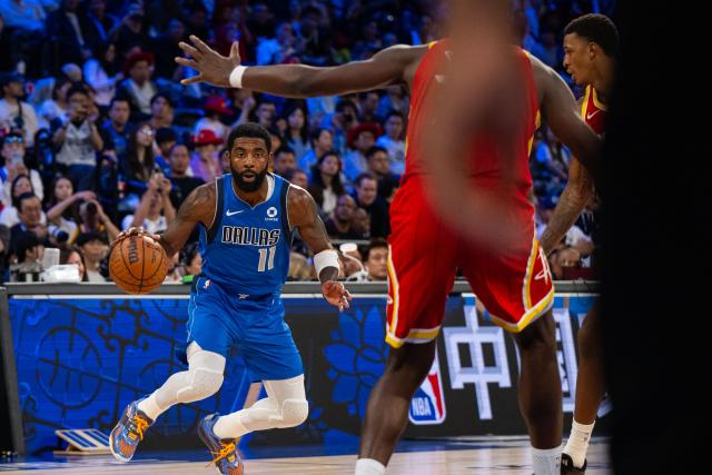 (261011) -- MACAO, Oct. 11, 2026 (Xinhua) -- Kyrie Irving (L) of Dallas Mavericks dribbles during the 2026-2027 NBA preseason game between Dallas Mavericks and Houston Rockets in Macao, south China, on Oct. 11, 2026. (Xinhua/Cheong Kam Ka)