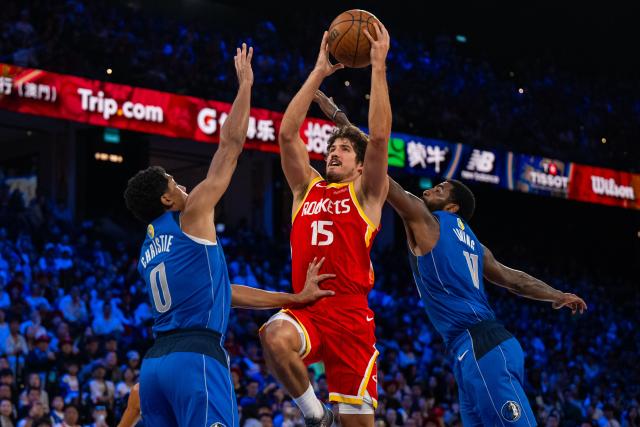 (261011) -- MACAO, Oct. 11, 2026 (Xinhua) -- Reed Sheppard (C) of Houston Rockets goes for a layup during the 2026-2027 NBA preseason game between Dallas Mavericks and Houston Rockets in Macao, south China, on Oct. 11, 2026. (Xinhua/Cheong Kam Ka)