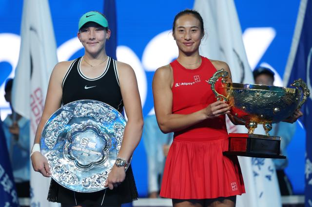 (261011) -- BEIJING, Oct. 11, 2026 (Xinhua) -- Zheng Qinwen (R) and Mirra Andreeva pose with their trophies during the awarding ceremony after the women's singles final between Zheng Qinwen of China and Mirra Andreeva of Russia at 2026 China Open tennis tournament in Beijing, China, Oct. 11, 2026. (Xinhua/Zhang Chenlin)