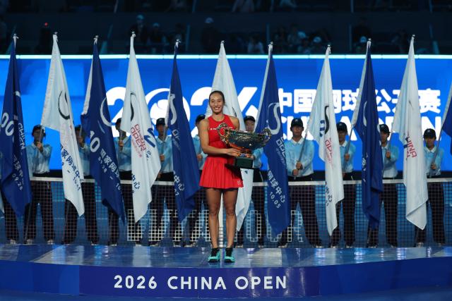 (261011) -- BEIJING, Oct. 11, 2026 (Xinhua) -- Zheng Qinwen poses with the trophy during the awarding ceremony after the women's singles final between Zheng Qinwen of China and Mirra Andreeva of Russia at 2026 China Open tennis tournament in Beijing, China, Oct. 11, 2026. (Xinhua/Zhang Chenlin)