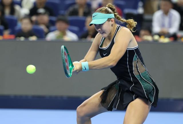 (261011) -- BEIJING, Oct. 11, 2026 (Xinhua) -- Mirra Andreeva hits a return during the women's singles final between Zheng Qinwen of China and Mirra Andreeva of Russia at 2026 China Open tennis tournament in Beijing, China, Oct. 11, 2026. (Xinhua/Zhang Chenlin)