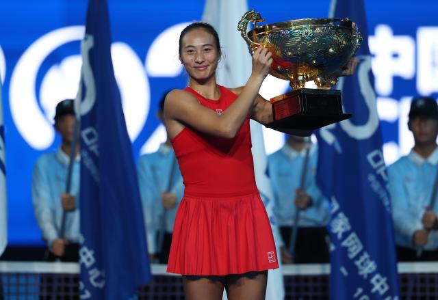 (261011) -- BEIJING, Oct. 11, 2026 (Xinhua) -- Zheng Qinwen poses with the trophy during the awarding ceremony after the women's singles final between Zheng Qinwen of China and Mirra Andreeva of Russia at 2026 China Open tennis tournament in Beijing, China, Oct. 11, 2026. (Xinhua/Zhang Chenlin)