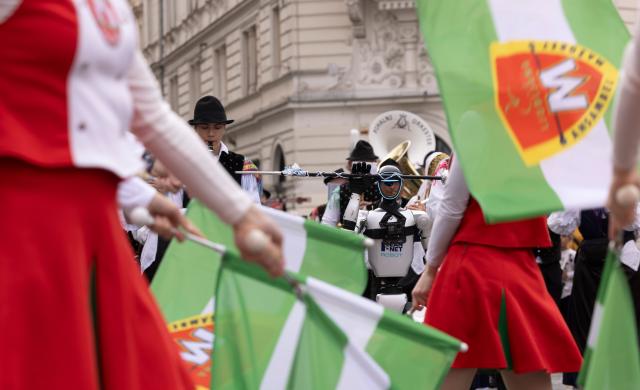 (261011) -- LJUBLJANA, Oct. 11, 2026 (Xinhua) -- A Unitree G1 humanoid robot conducts the Ljubljana Wind Orchestra during the parade of the Ljubljana Wind Orchestra in Ljubljana, Slovenia, Oct. 11, 2026. (Photo by Zeljko Stevanic/Xinhua)