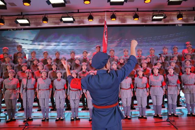 (261012) -- NANCHANG, Oct. 12, 2026 (Xinhua) -- The Long March Origin choir perform at a middle school in Yudu County, east China's Jiangxi Province, Sept. 3, 2026. This year marks the 90th anniversary of the victory of the Long March. As one of its important starting points, Yudu County in east China's Jiangxi Province, a place best known as the starting point of the Long March by the Central Red Army, the historic military maneuver in modern Chinese history, has become more than a place of remembrance.
   It was from Yudu that more than 80,000 Red Army soldiers crossed the Yudu River and began the Long March in 1934, the roughly 12,500-kilometer trek later described by American journalist Harrison Salisbury as "a great human epic."
   On the stone tablet in front of the memorial museum of the Central Red Army's departure for the Long March here in Yudu, three Chinese characters meaning "Long March Origin" are engraved. The "Long March Origin" not only indicates that this place was the starting point of the important strategic transfer of the Red Army at that time, but also carries the profound understanding of the Long March spirit by the people of Yudu to this day.
   You can see the words "Long March Origin" frequently in Yudu, and the Long March Origin choir is a prominent presence.
   In this red revolutionary land of Yudu, almost everyone can share family stories connected to the Red Army's Long March. The Long March Origin choir, established in 2010, is composed of over 100 descendants of Red Army soldiers from all walks of life in the county. Over these years, they have not only performed the "Suite of Songs on the Long March" in Yudu and across Jiangxi in their spare time, but also carried forward the spirit of the Long March along the Long March route with their songs.
   The choir's first performance was staged on June 30, 2011, which was dedicated to the 90th anniversary of the founding of the Communist Party of China. So far the choir has performed over 730 charity performances. "We hope that the choir will complete 1,000 performances by the 100th anniversary of the victory of the Long March," said Zou Weimin, the director of the choir. (Xinhua/Zhou Mi)