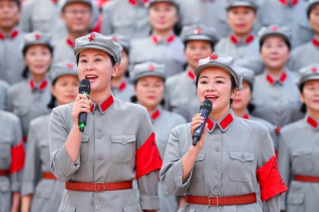 (261012) -- NANCHANG, Oct. 12, 2026 (Xinhua) -- The Long March Origin choir rehearse at the cultural center in Yudu County, east China's Jiangxi Province, July 28, 2026. This year marks the 90th anniversary of the victory of the Long March. As one of its important starting points, Yudu County in east China's Jiangxi Province, a place best known as the starting point of the Long March by the Central Red Army, the historic military maneuver in modern Chinese history, has become more than a place of remembrance.
   It was from Yudu that more than 80,000 Red Army soldiers crossed the Yudu River and began the Long March in 1934, the roughly 12,500-kilometer trek later described by American journalist Harrison Salisbury as "a great human epic."
   On the stone tablet in front of the memorial museum of the Central Red Army's departure for the Long March here in Yudu, three Chinese characters meaning "Long March Origin" are engraved. The "Long March Origin" not only indicates that this place was the starting point of the important strategic transfer of the Red Army at that time, but also carries the profound understanding of the Long March spirit by the people of Yudu to this day.
   You can see the words "Long March Origin" frequently in Yudu, and the Long March Origin choir is a prominent presence.
   In this red revolutionary land of Yudu, almost everyone can share family stories connected to the Red Army's Long March. The Long March Origin choir, established in 2010, is composed of over 100 descendants of Red Army soldiers from all walks of life in the county. Over these years, they have not only performed the "Suite of Songs on the Long March" in Yudu and across Jiangxi in their spare time, but also carried forward the spirit of the Long March along the Long March route with their songs.
   The choir's first performance was staged on June 30, 2011, which was dedicated to the 90th anniversary of the founding of the Communist Party of China. So far the choir has performed over 730 charity performances. "We hope that the choir will complete 1,000 performances by the 100th anniversary of the victory of the Long March," said Zou Weimin, the director of the choir. (Xinhua/Liu Jinhai)
